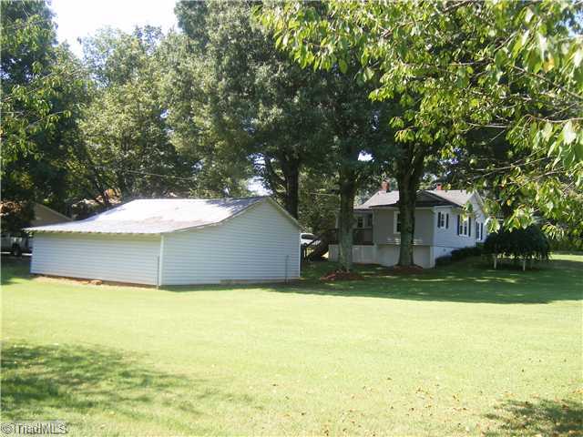 7701 Broad Street Rural Hall, NC 27045 - Photo 6 of 16 Exterior Front. This view shows size of lot. I m standing on the back right corner. Great space for garden or maybe even a pool....