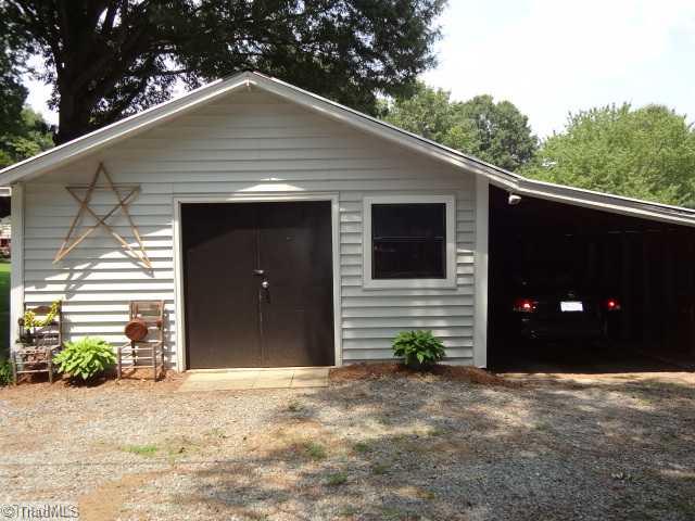 7701 Broad Street Rural Hall, NC 27045 - Photo 7 of 16 Exterior Front. 260 sq ft workshop/storage shed with an attached carport. Does have concrete slab and power.