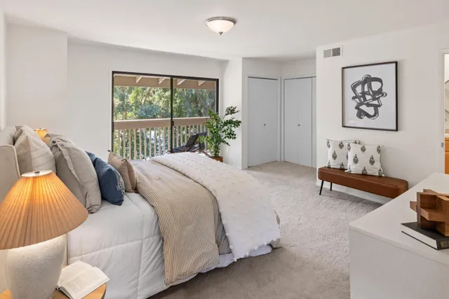 a bed room with a bed and a chair