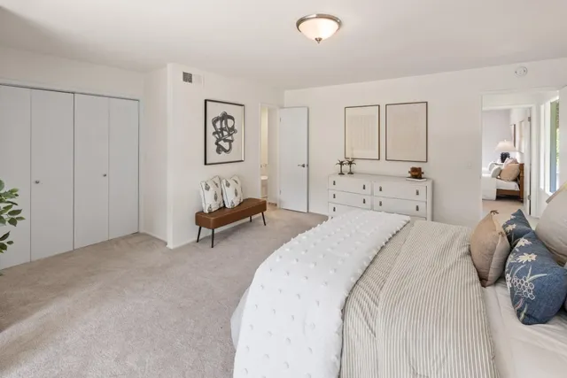 a bed room with a bed and a night stand