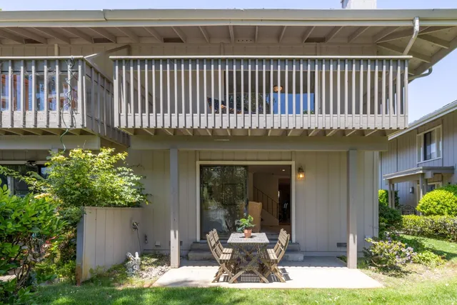 a view of a patio with chair and tables back yard of the house