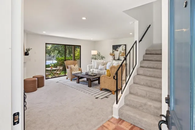 a living room with furniture and a staircase
