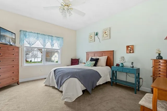 a spacious bedroom with a bed and a window