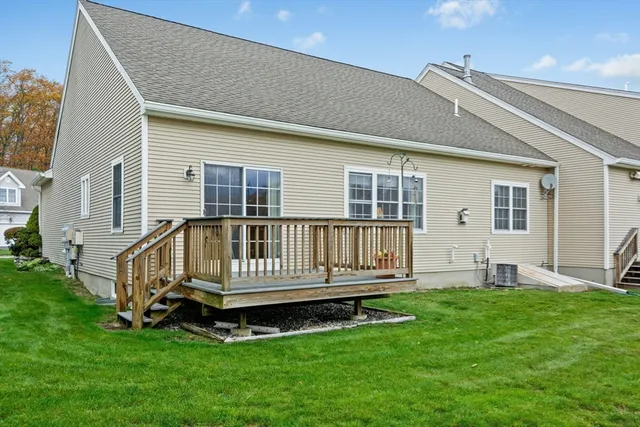 a front view of a house with a yard and deck