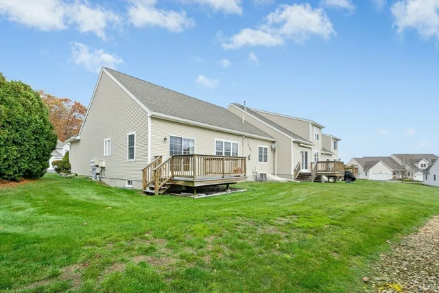 a view of a house with a yard and sitting area