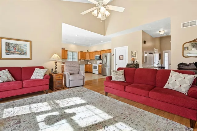 a living room with furniture and a chandelier