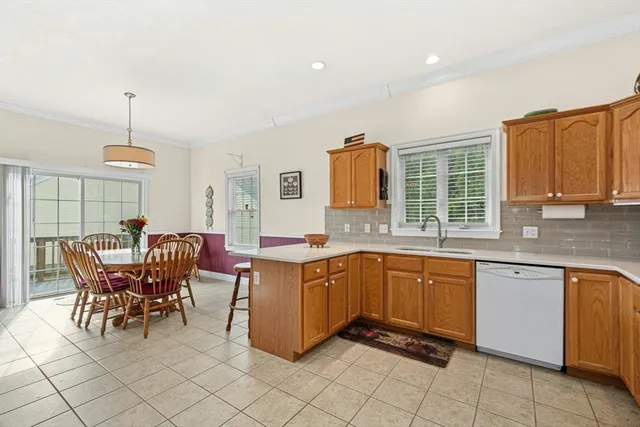 a kitchen with stainless steel appliances granite countertop a sink table and chairs