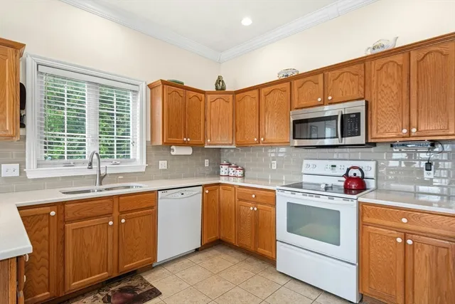 a kitchen with stainless steel appliances wooden cabinets and a sink