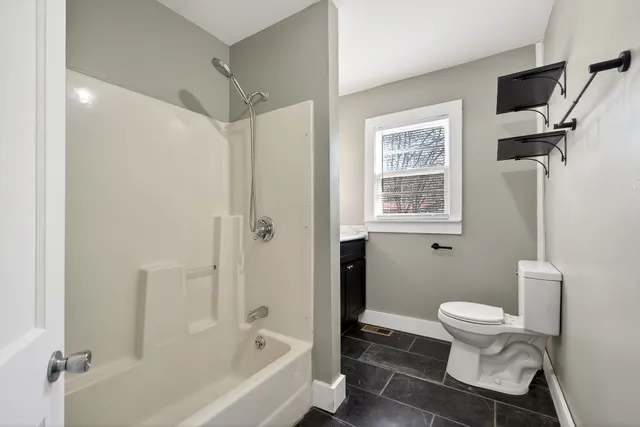 a bathroom with a toilet and a shower