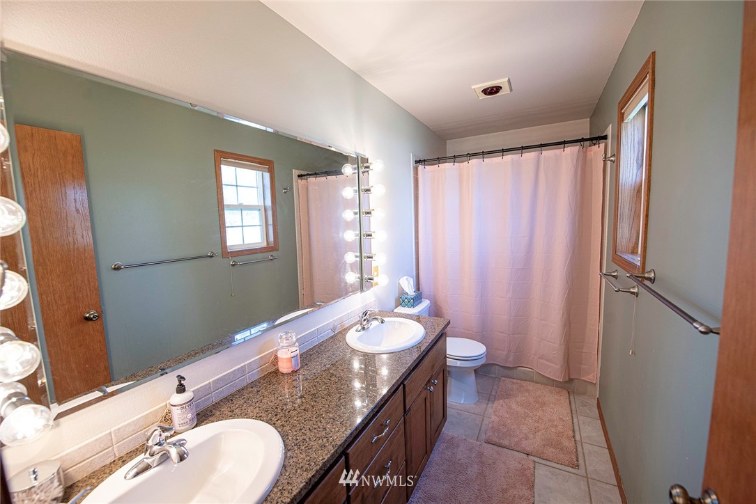 7483 Frog Hollow Road Touchet, WA 99360 - Photo 14 of 25 a bathroom with a granite countertop sink toilet and shower