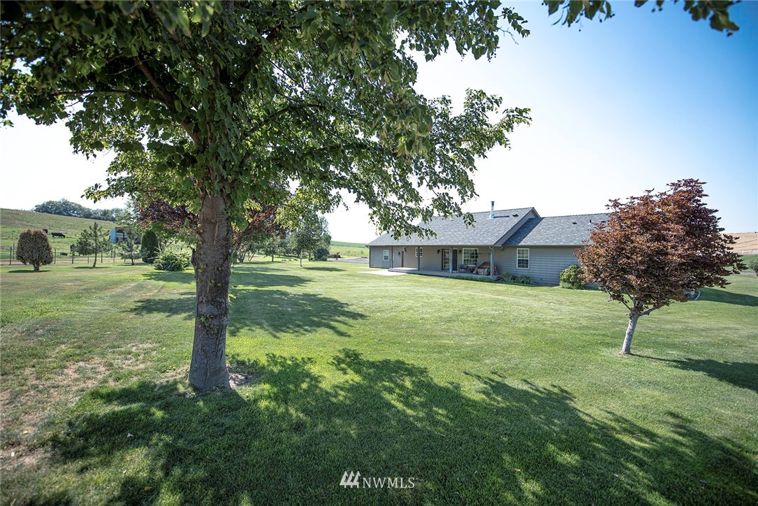 7483 Frog Hollow Road Touchet, WA 99360 - Photo 22 of 25 a view of a house with a backyard
