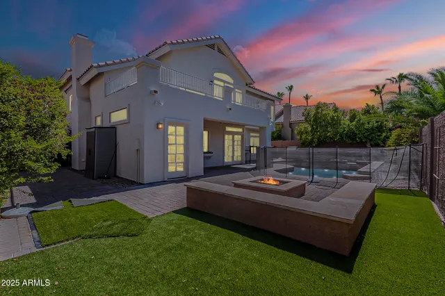 a front view of a house with garden and patio