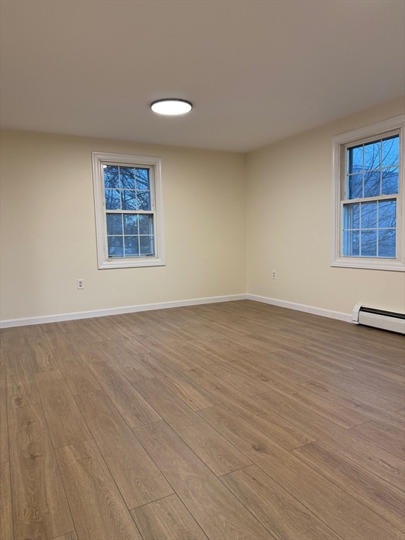 17 Horace Street, Unit 2 Boston, MA 02128 - Photo 5 of 14 an empty room with wooden floor and windows