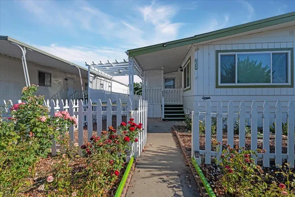 a view of a house with a flower garden