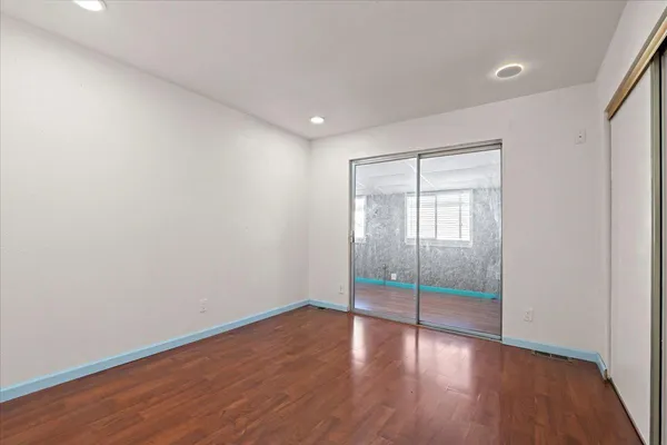 a view of wooden floor and windows in a room