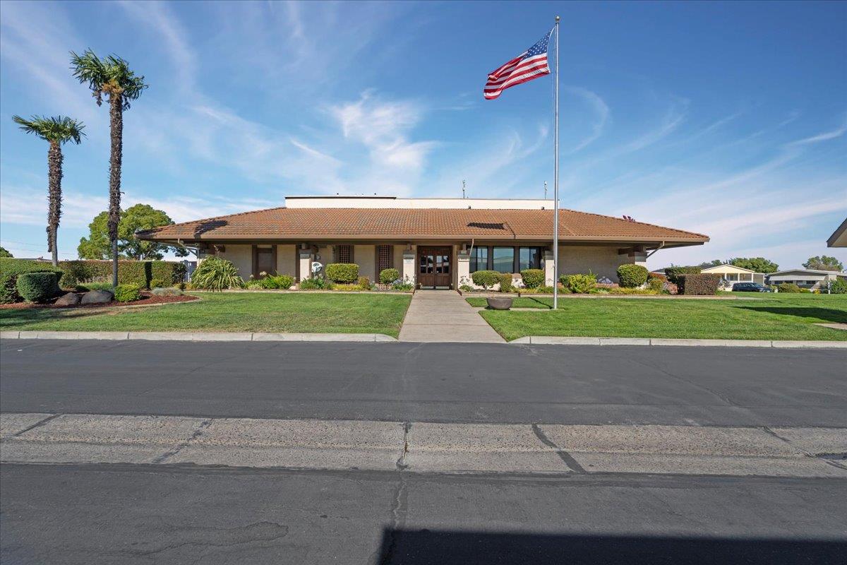 6300 Election Lane, Unit 118 Sacramento, CA 95828 - Photo 26 of 38 a front view of a house with a yard and potted plants
