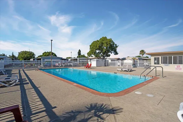 a view of a swimming pool with a lounge chairs
