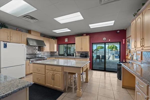 a kitchen with stainless steel appliances granite countertop a stove refrigerator sink and cabinets