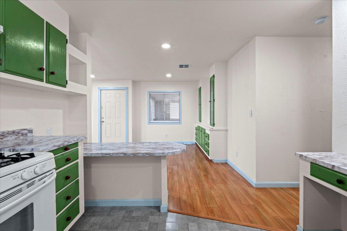 6300 Election Lane, Unit 118 Sacramento, CA 95828 - Photo 8 of 38 a kitchen with kitchen island granite countertop a stove and a sink