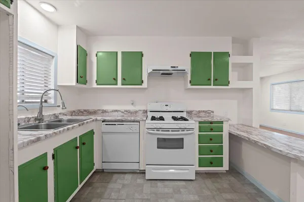 a kitchen with a stove sink and cabinets