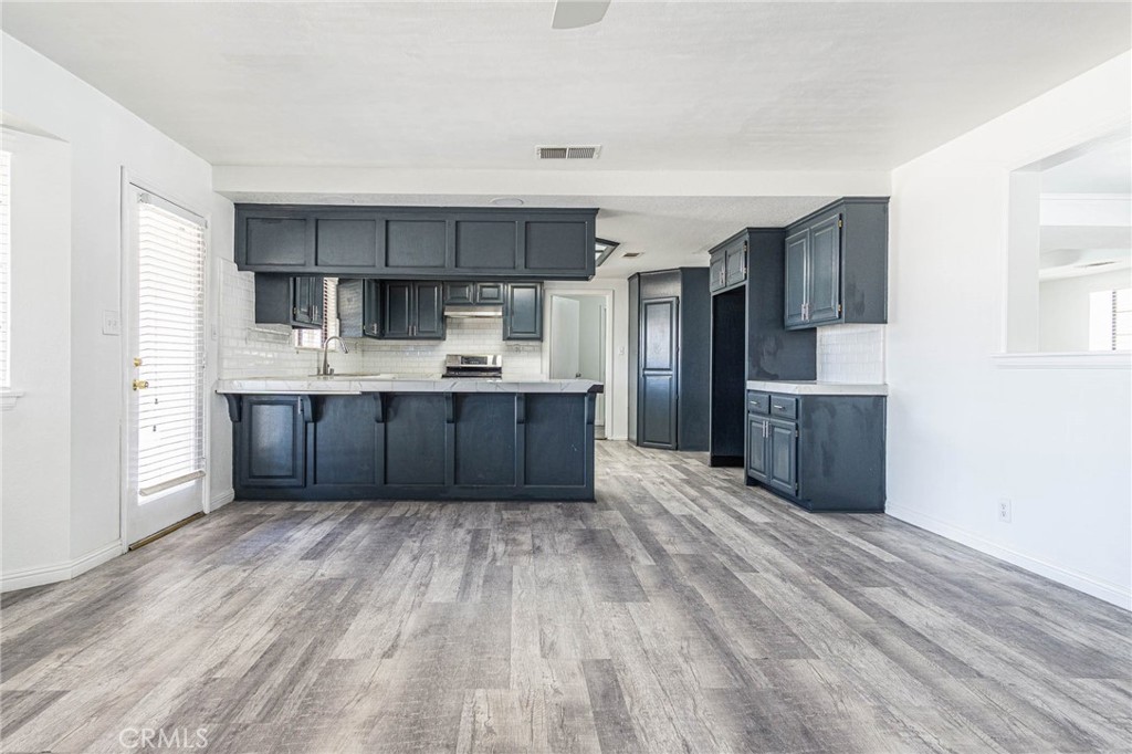 13114 Choco Road Apple Valley, CA 92308 - Photo 12 of 75 a kitchen with stainless steel appliances a refrigerator and a stove top oven
