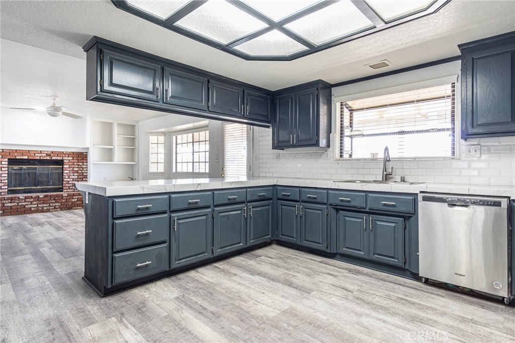13114 Choco Road Apple Valley, CA 92308 - Photo 15 of 75 a kitchen with stainless steel appliances granite countertop a sink and cabinets