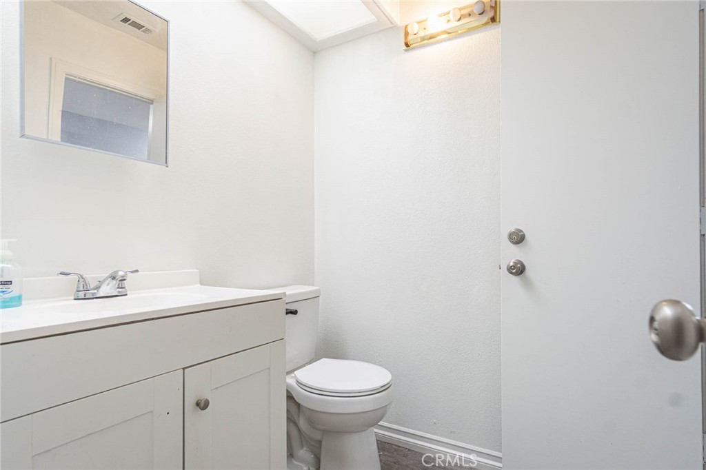 13114 Choco Road Apple Valley, CA 92308 - Photo 25 of 75 a bathroom with a sink a toilet and a mirror