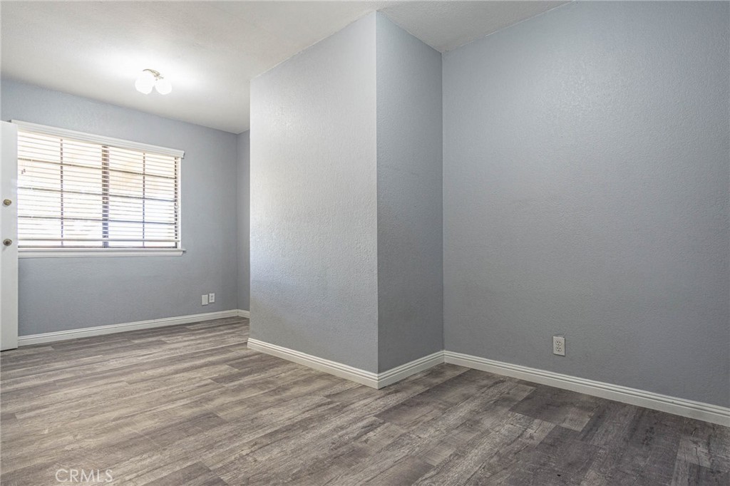13114 Choco Road Apple Valley, CA 92308 - Photo 33 of 75 an empty room with wooden floor and windows