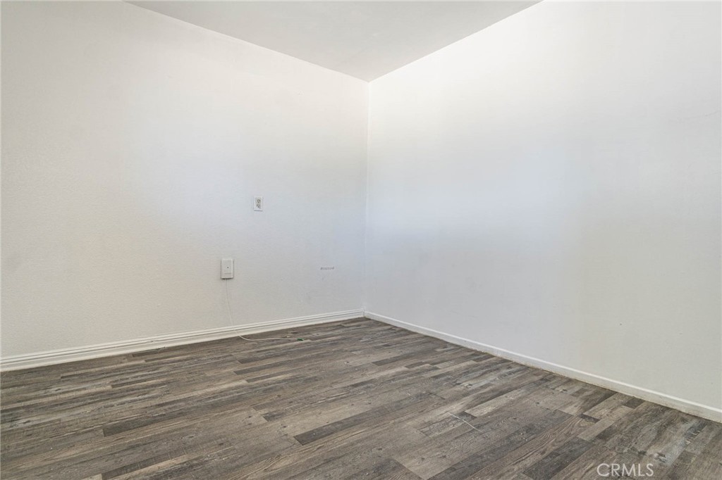 13114 Choco Road Apple Valley, CA 92308 - Photo 34 of 75 a view of an empty room with wooden floor