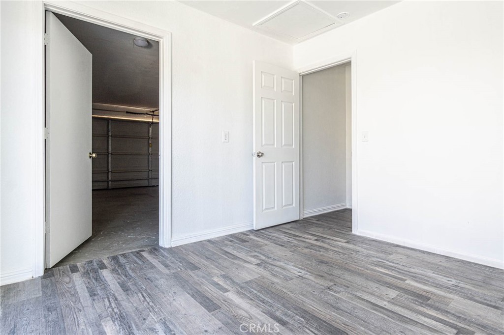 13114 Choco Road Apple Valley, CA 92308 - Photo 37 of 75 a view of an empty room with wooden floor