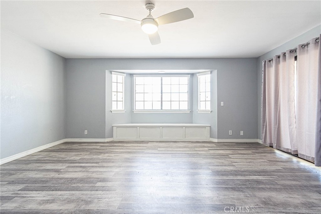 13114 Choco Road Apple Valley, CA 92308 - Photo 40 of 75 a view of an empty room with a window and wooden floor