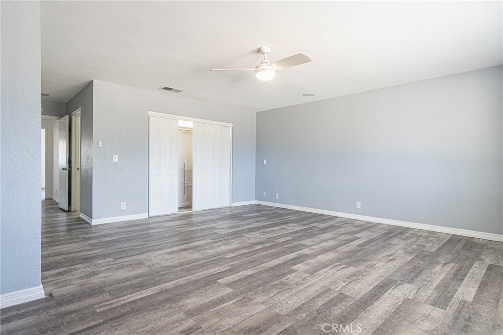 13114 Choco Road Apple Valley, CA 92308 - Photo 42 of 75 a view of an empty room with wooden floor