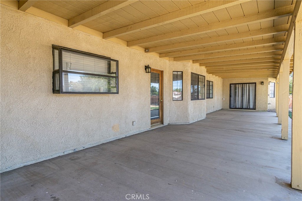 13114 Choco Road Apple Valley, CA 92308 - Photo 54 of 75 a view of an empty room with wooden floor and a window