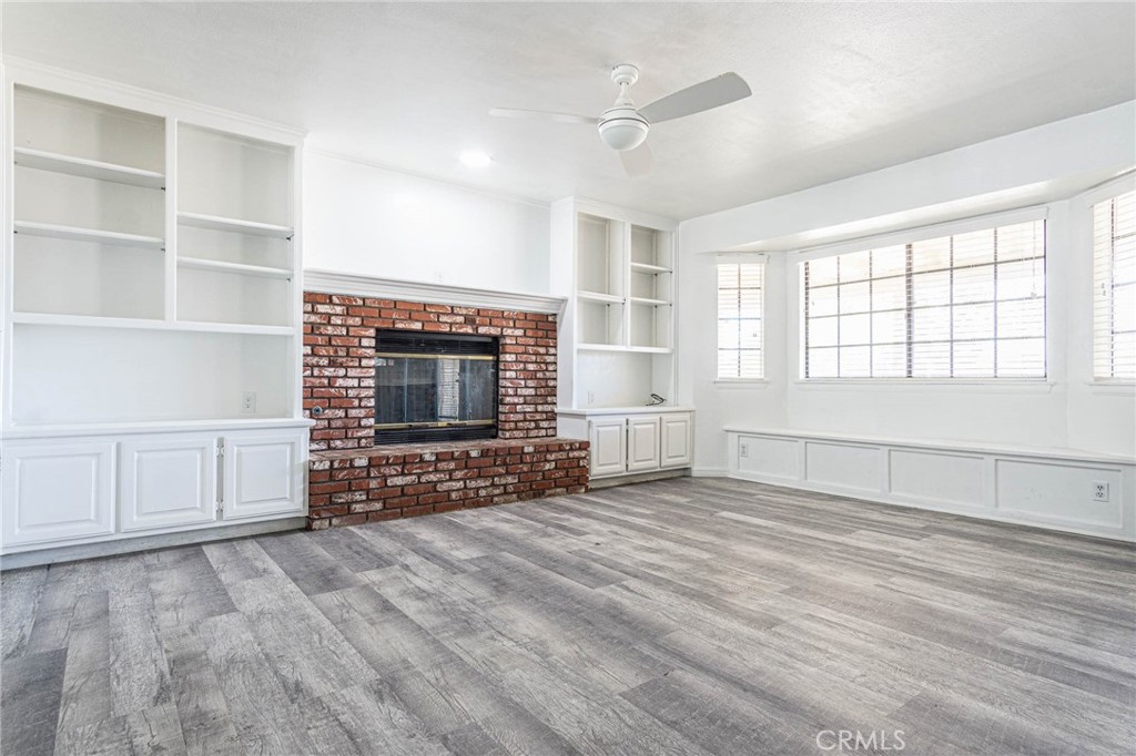 13114 Choco Road Apple Valley, CA 92308 - Photo 10 of 75 a view of an empty room with a fireplace and a window