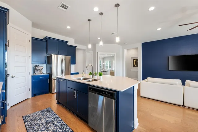 a kitchen with a refrigerator a sink and a microwave
