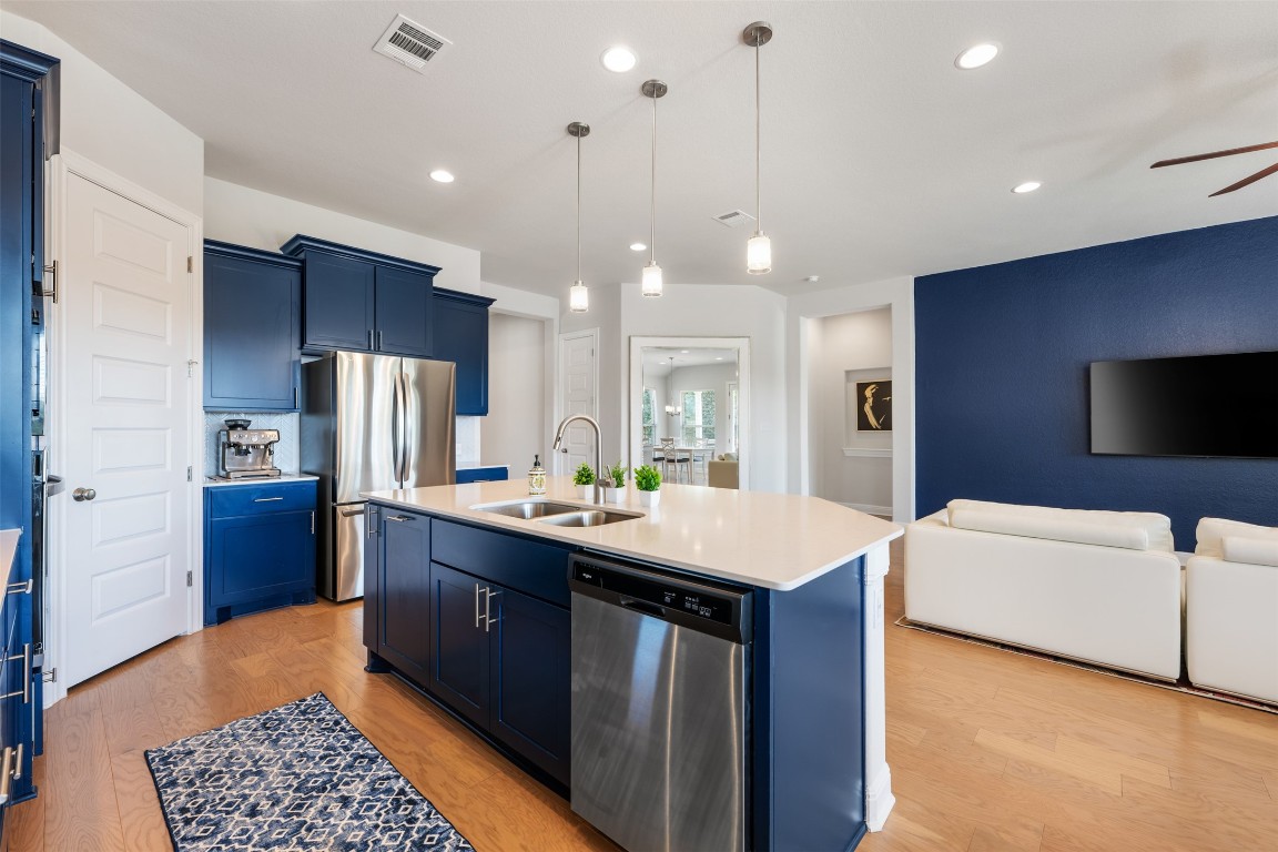 686 Treadwell Lane Kyle, TX 78640 - Photo 16 of 40 a kitchen with a refrigerator a sink and a microwave