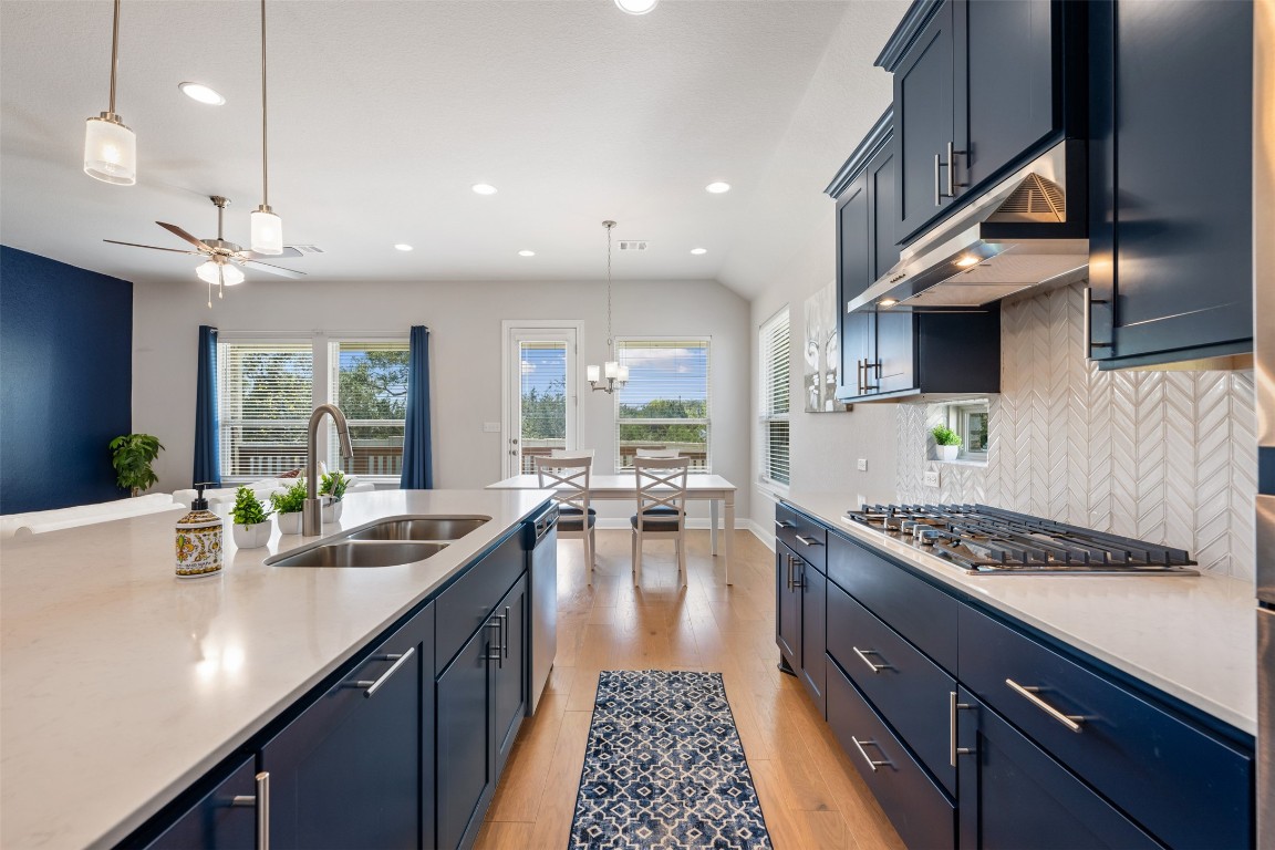 686 Treadwell Lane Kyle, TX 78640 - Photo 17 of 40 a kitchen with lots of counter space windows and appliances