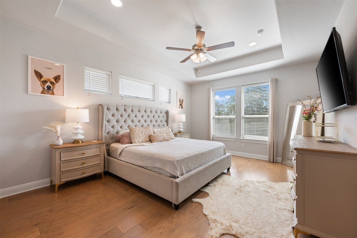 686 Treadwell Lane Kyle, TX 78640 - Photo 21 of 40 a bedroom with a bed flat screen tv and a large window