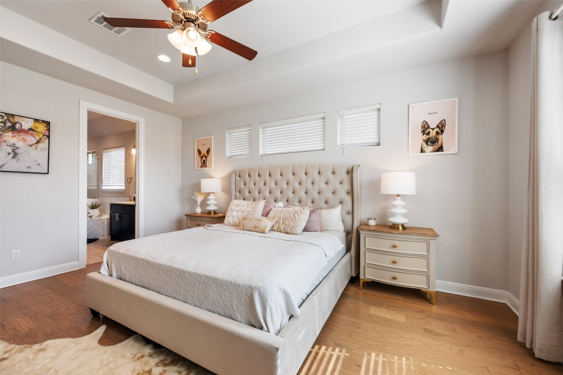 686 Treadwell Lane Kyle, TX 78640 - Photo 22 of 40 a bedroom with a bed and a chandelier