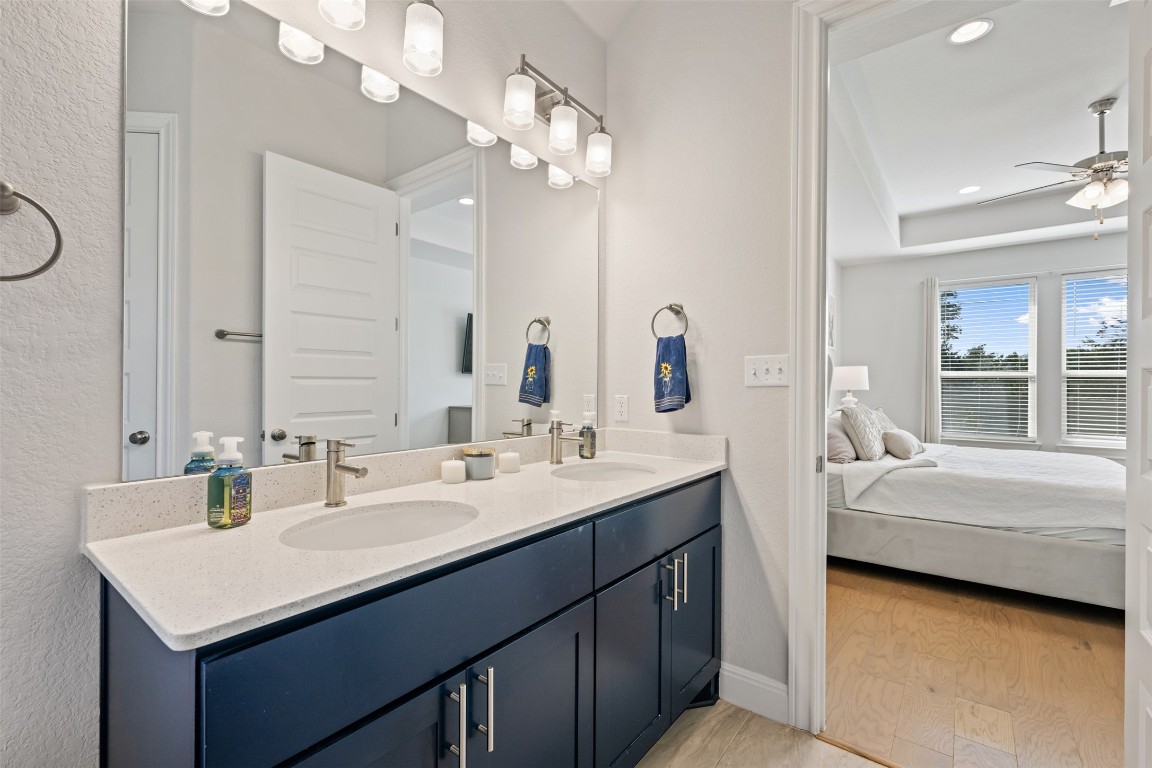 686 Treadwell Lane Kyle, TX 78640 - Photo 25 of 40 a en suite bathroom with a double vanity sink and a mirror