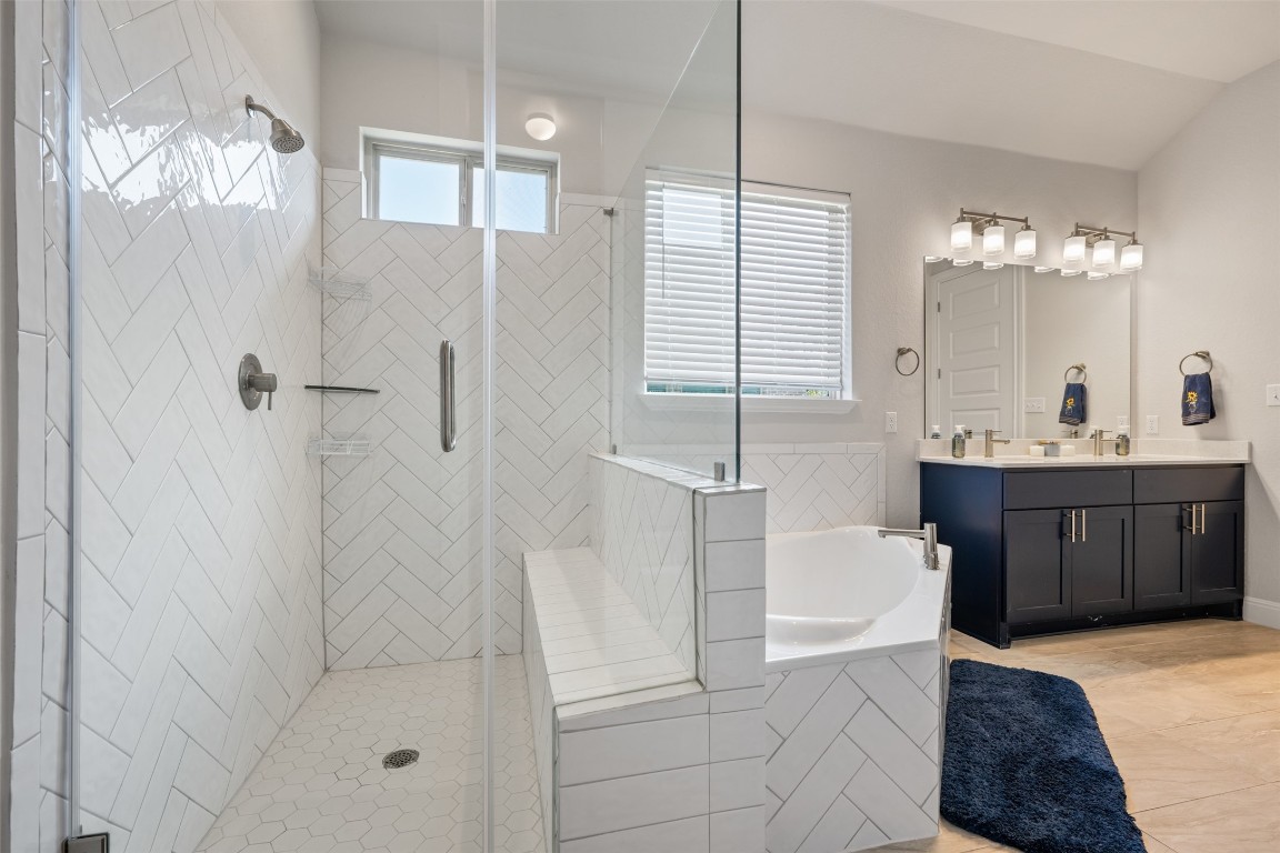 686 Treadwell Lane Kyle, TX 78640 - Photo 28 of 40 a bathroom with a tub sink and shower