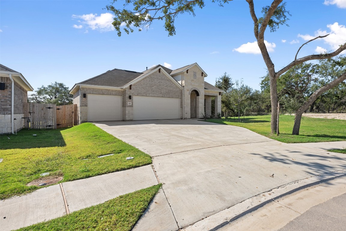686 Treadwell Lane Kyle, TX 78640 - Photo 40 of 40 a front view of a house with a garden and yard