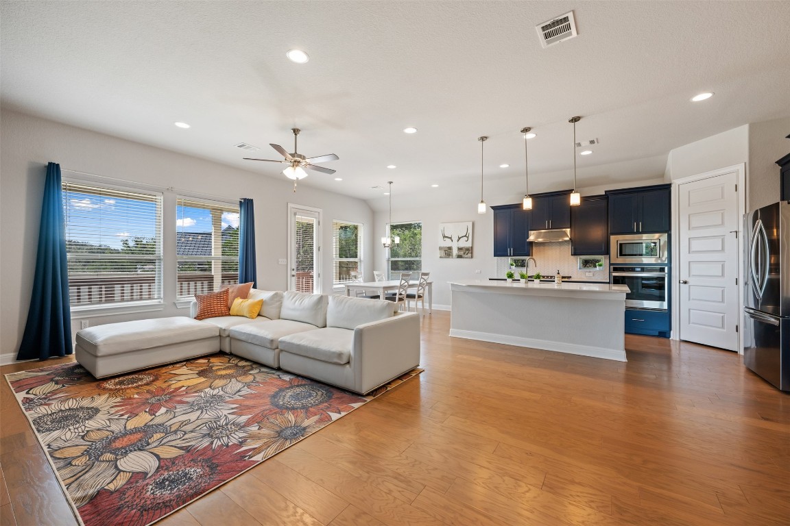 686 Treadwell Lane Kyle, TX 78640 - Photo 8 of 40 a living room with kitchen island furniture and a large window