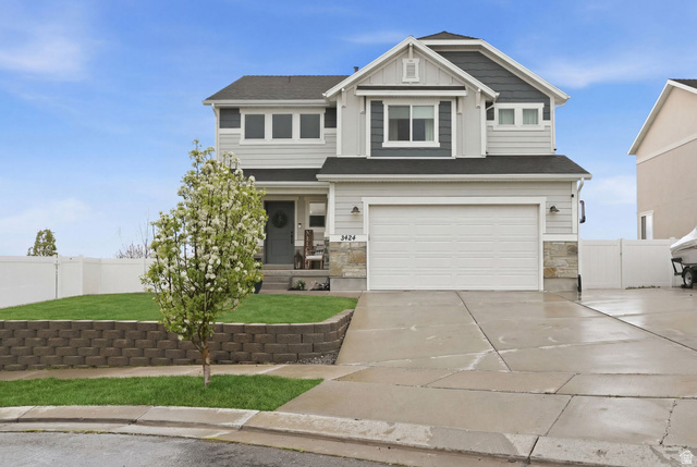 3424 Bridge Street Eagle Mountain, UT 84005 - Photo 1 of 1 Craftsman-style house featuring a porch, an attached garage, board and batten siding, concrete driveway, and stone siding