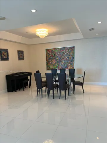 a living room with furniture a dining table and chairs