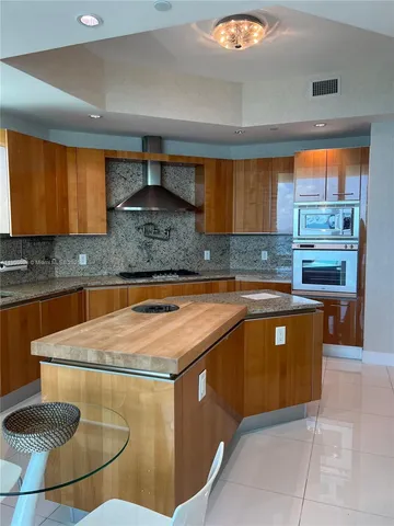 a kitchen with stainless steel appliances granite countertop a sink counter space and a window