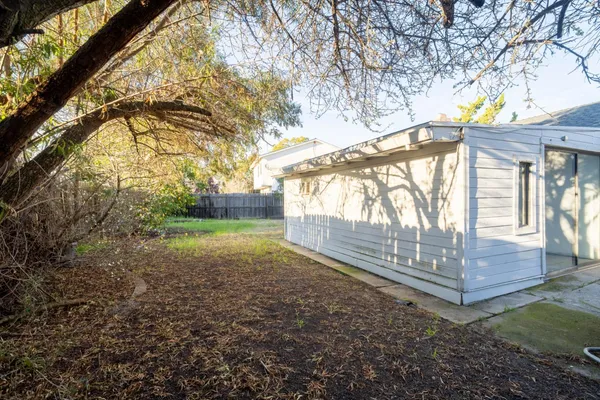 a backyard of a house with large trees and a lots of trees
