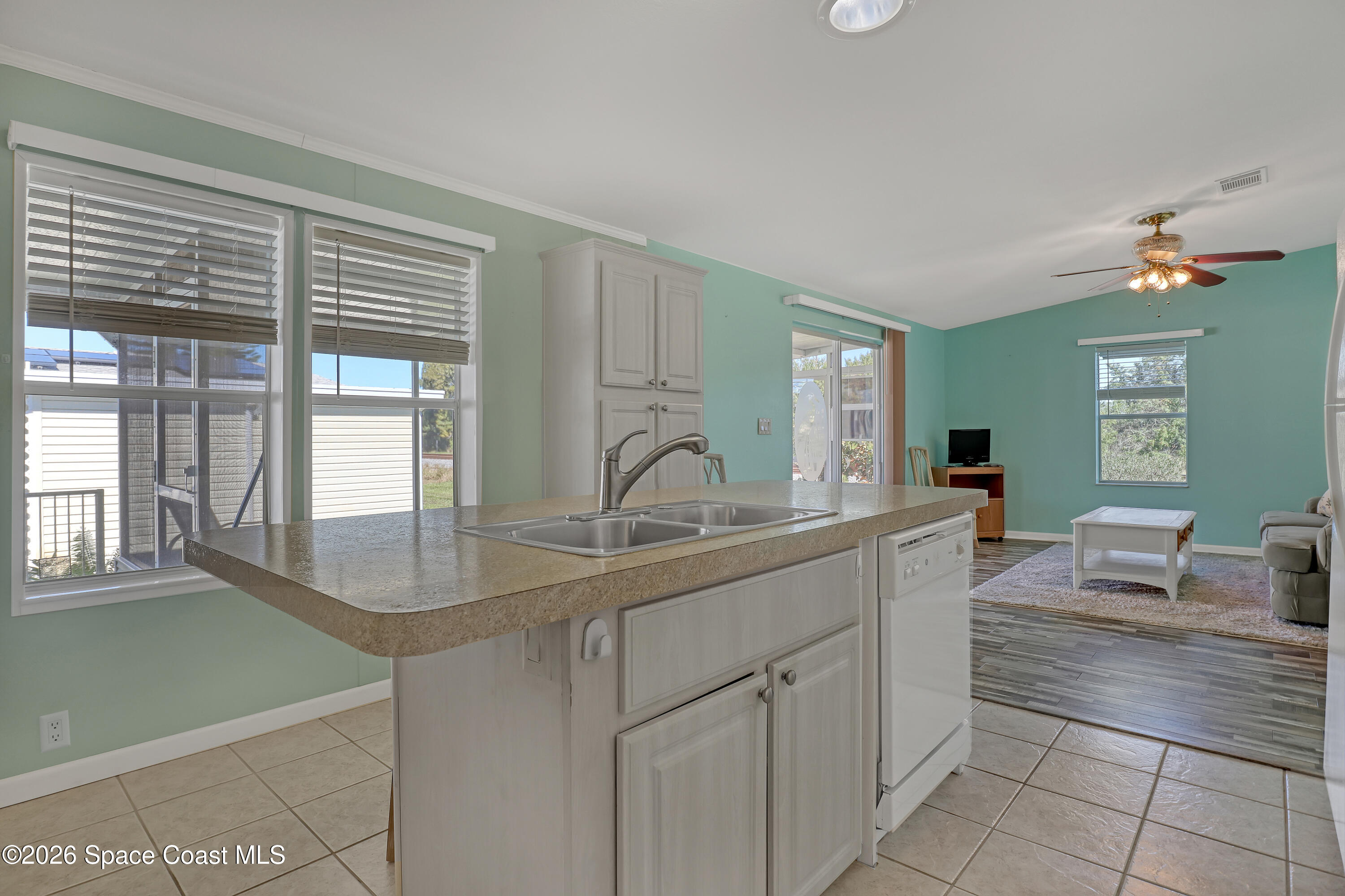 7547 Boxelder Road Micco, FL 32976 - Photo 17 of 53 a kitchen with cabinets a sink and appliances