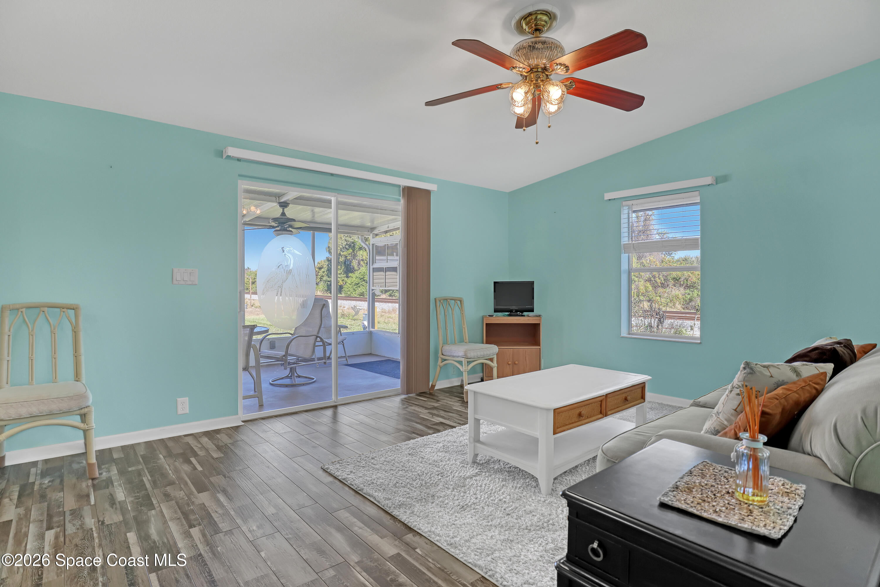 7547 Boxelder Road Micco, FL 32976 - Photo 18 of 53 a living room with furniture and a table