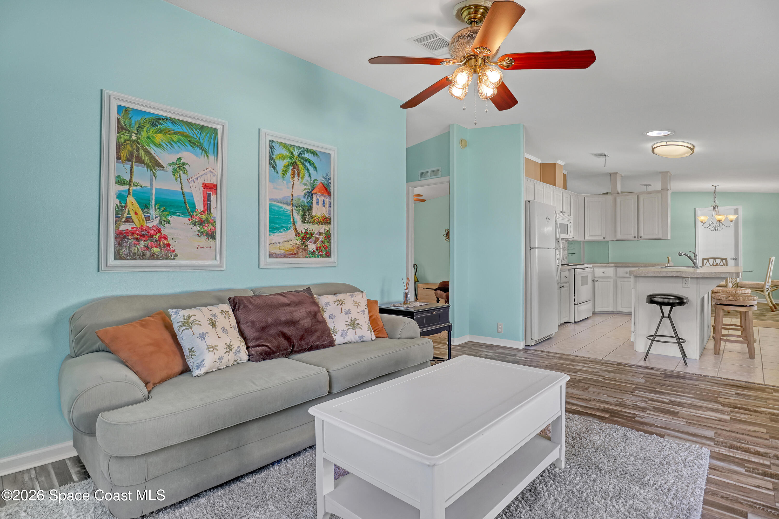 7547 Boxelder Road Micco, FL 32976 - Photo 20 of 53 a living room with furniture and kitchen view